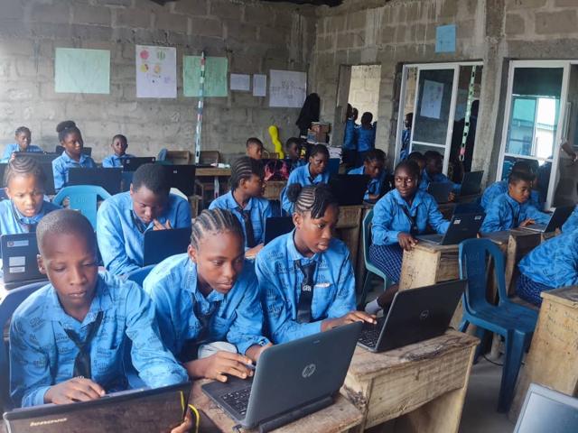 Students working on laptops in a computer class