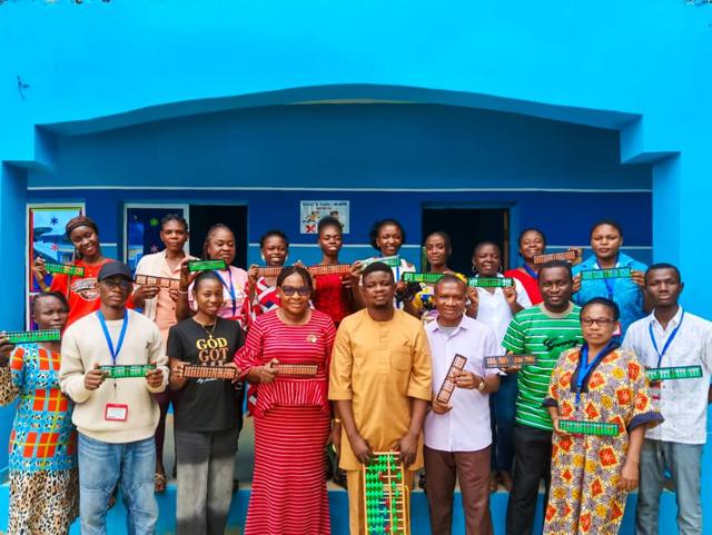 Geneviva Schools teachers and staff in front of the school building